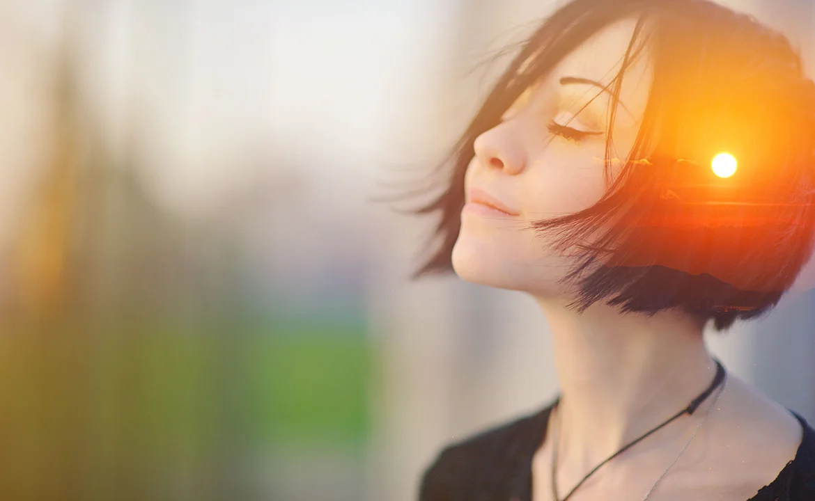 A woman with her eyes closed is exuding a sense of calmness.