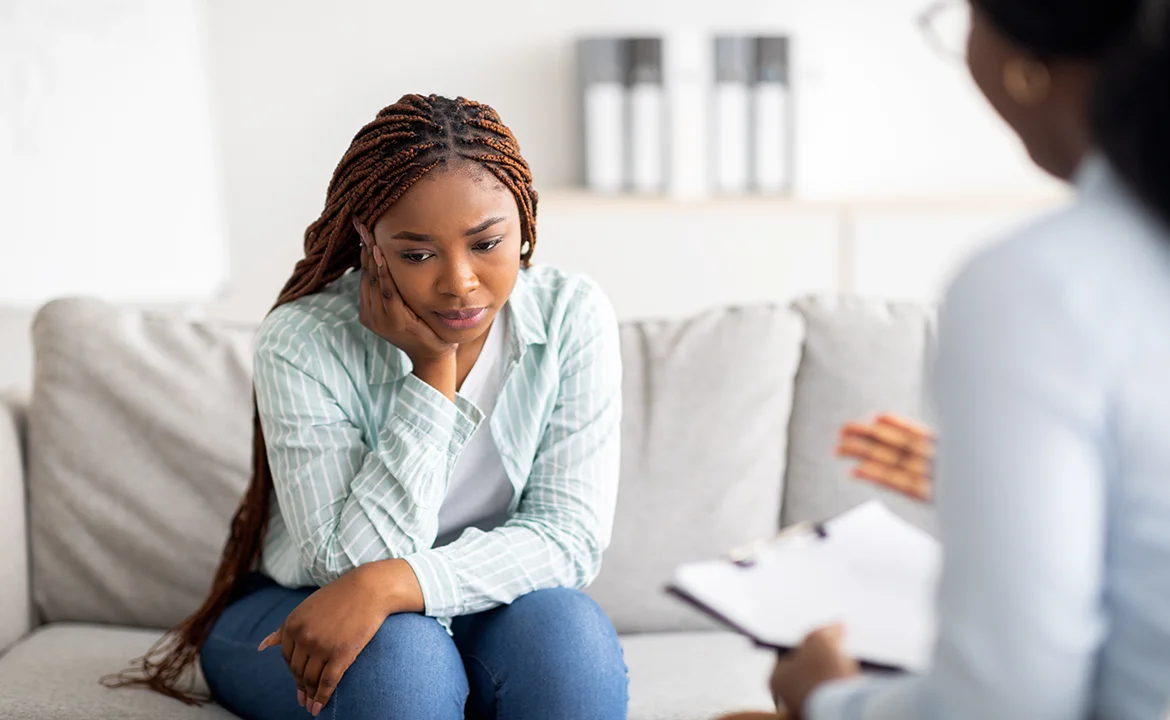a woman sitting on a couch in a counselling session
