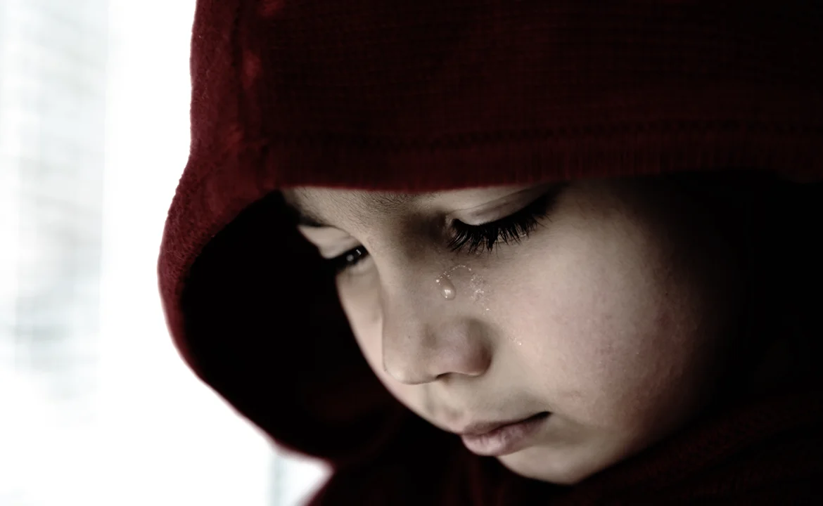 a child with a tear on his face